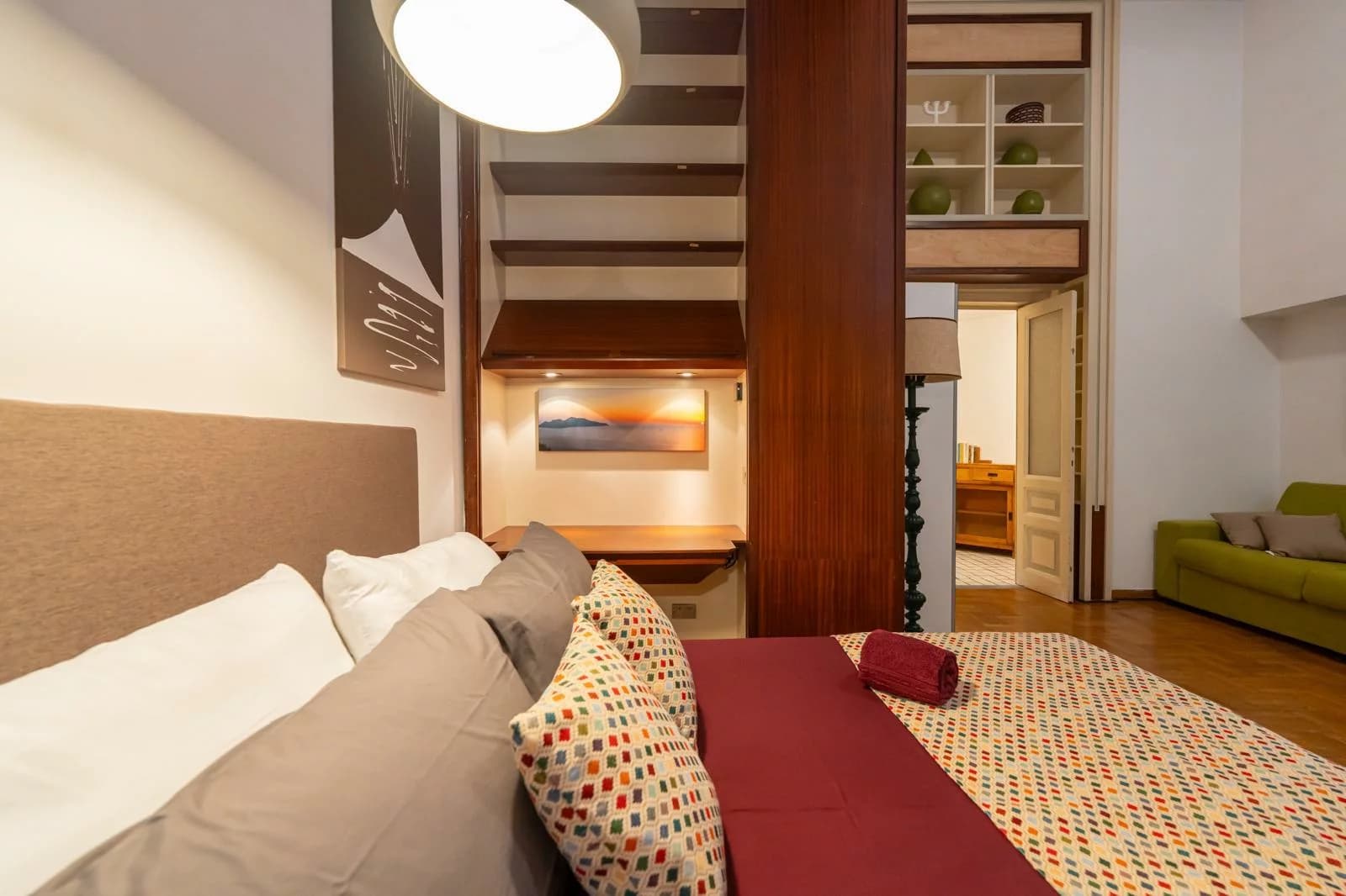 Camera matrimoniale della Suite della Nonna con cuscini patchwork colorati e luce calda